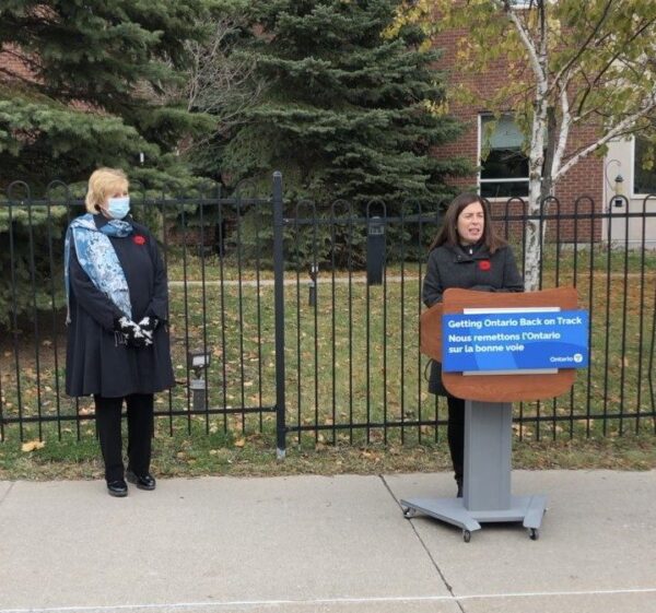 Laurie Scott stands with staff of the Ross Memorial Hospital near a podium