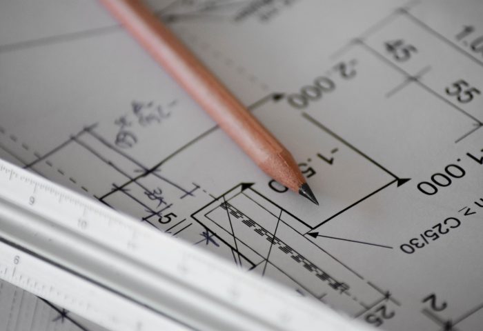 Blueprints with a pencil on a table
