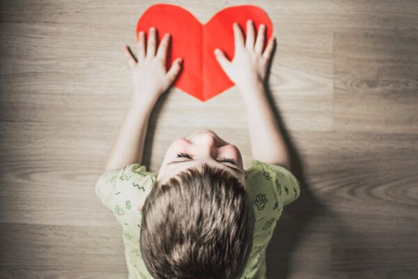 Child crafting a heart