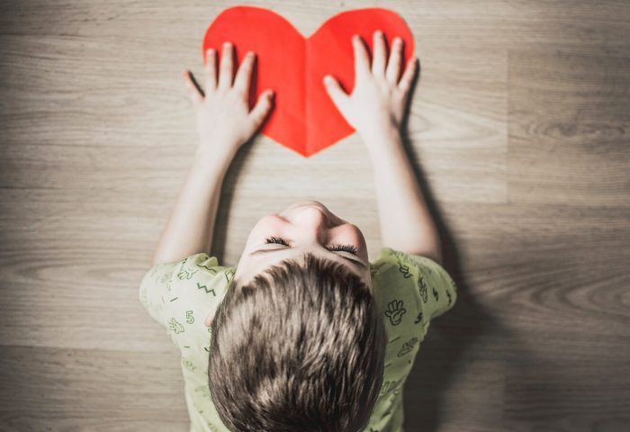 Child crafting a heart
