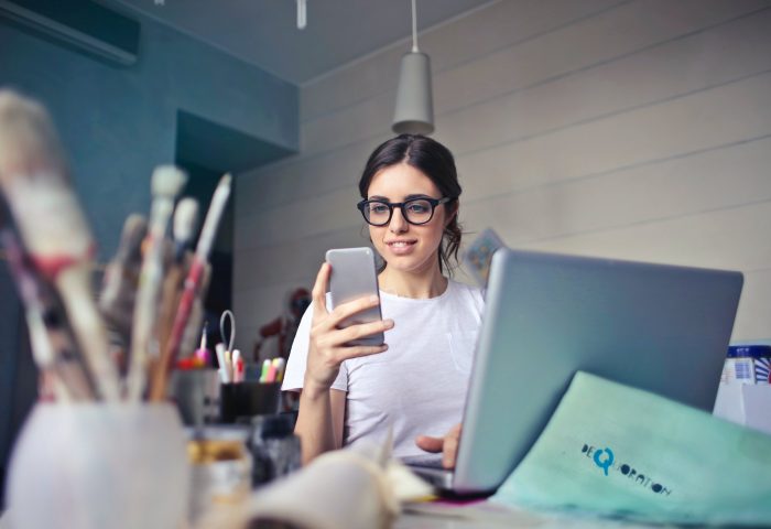 Young woman at a desk on her phone